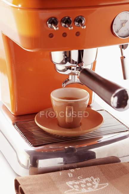 Cup of espresso on coffee machine — Stock Photo