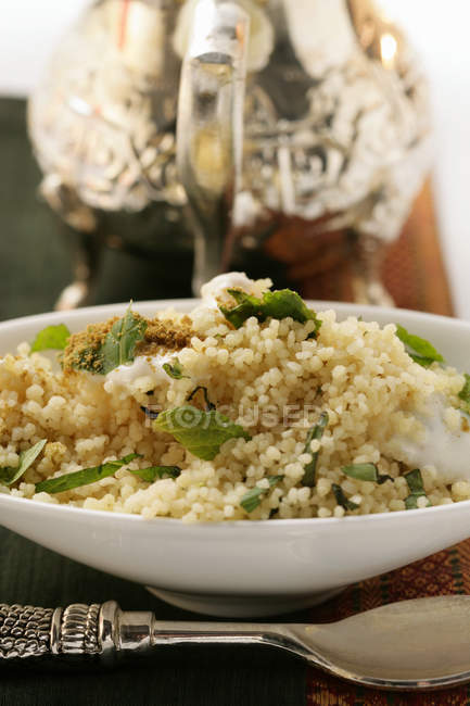 Couscous with yoghurt on plate — Stock Photo