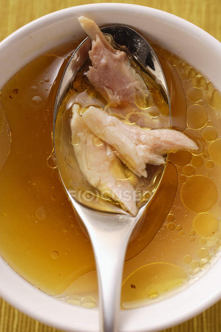 Closeup top view of clear soup with chicken — Stock Photo