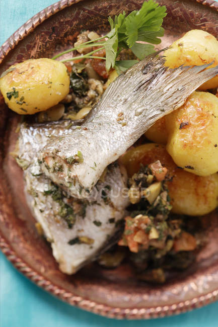 Sea bass with roast potatoes — Stock Photo