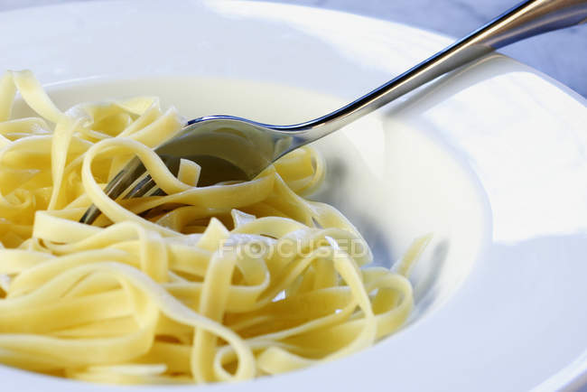 Tagliatelle pasta with fork — Stock Photo