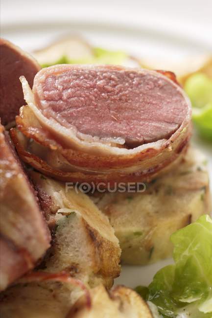 Venison fillet in bacon — Stock Photo