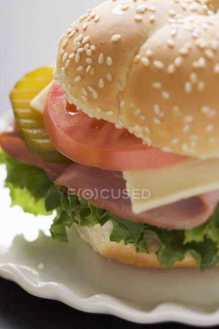 Tomato and gherkin in roll — Stock Photo