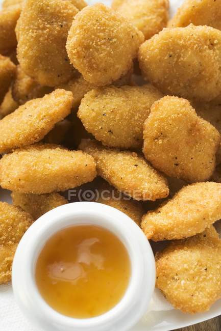 Chicken nuggets with apricot sauce — Stock Photo