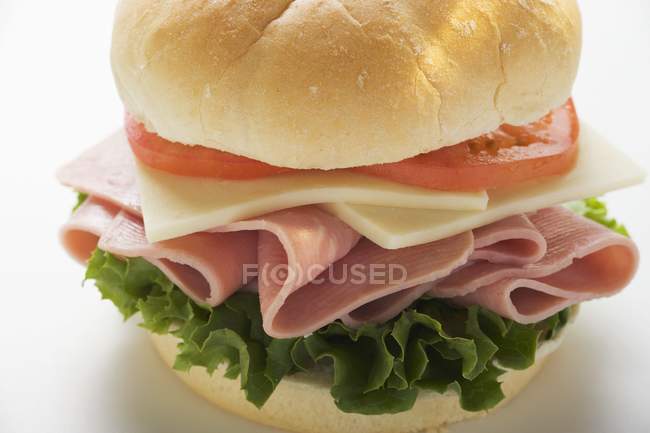 Cheese and tomato in kaiser roll — Stock Photo