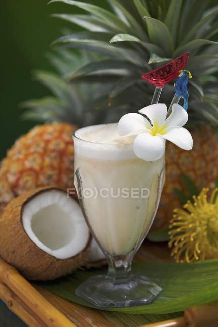 Closeup view of Pina Colada cocktail garnished with plumeria — Stock Photo