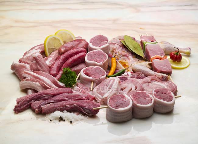 Raw meats and sausages for grilling — Stock Photo