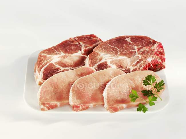 Slices of raw pork neck and loin — Stock Photo