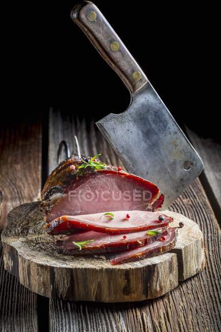Sliced Smoked ham and meat cleaver — Stock Photo