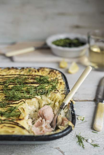 Fish pie with dill on baking tray — Stock Photo