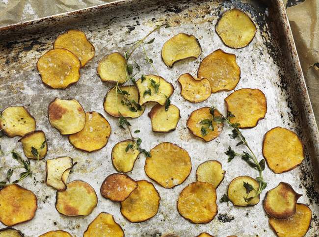Potato crisps on a baking tray — Stock Photo