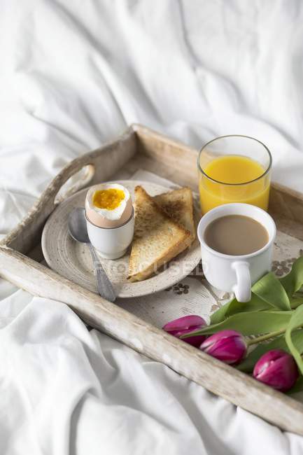 Breakfast tray in bed — Stock Photo
