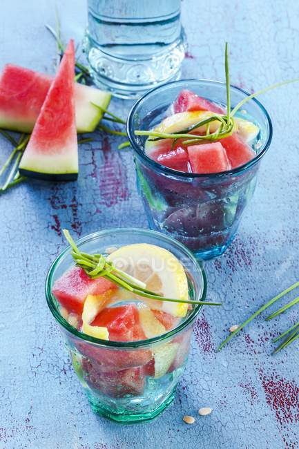 Watermelon with lemon slices and herbs — Stock Photo