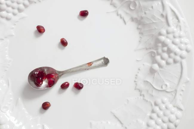 Pomegranate seeds on spoon — Stock Photo