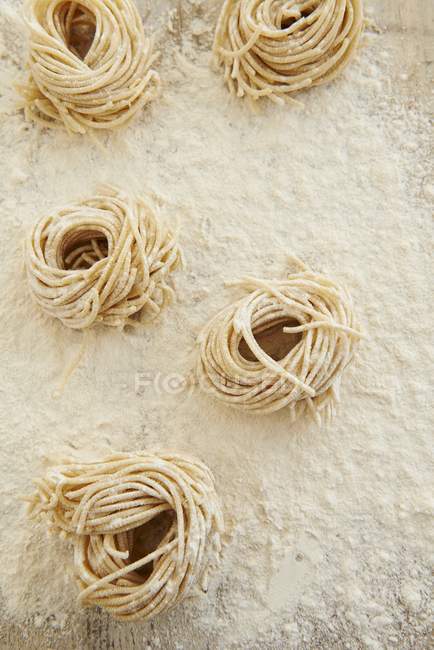 Uncooked Fresh spaghetti nests — Stock Photo