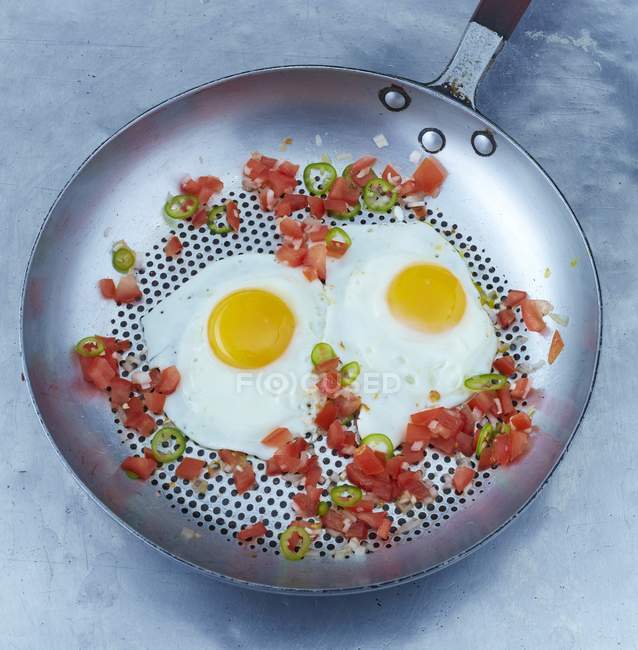 Fried eggs with chilli rings — Stock Photo