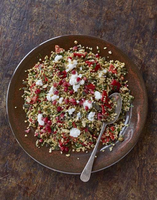 Freekah salad with pomegranate syrup and ricotta — Stock Photo