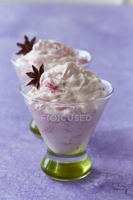 Closeup view of rhubarb fool with anise stars in glasses — Stock Photo