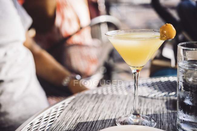 Cocktail in glass over table — Stock Photo