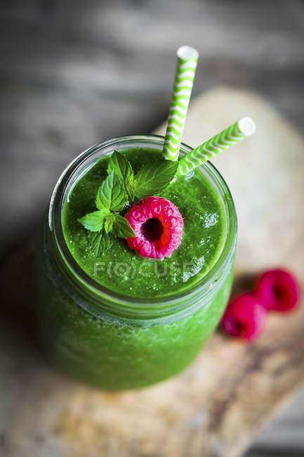 Green smoothie with raspberry — Stock Photo