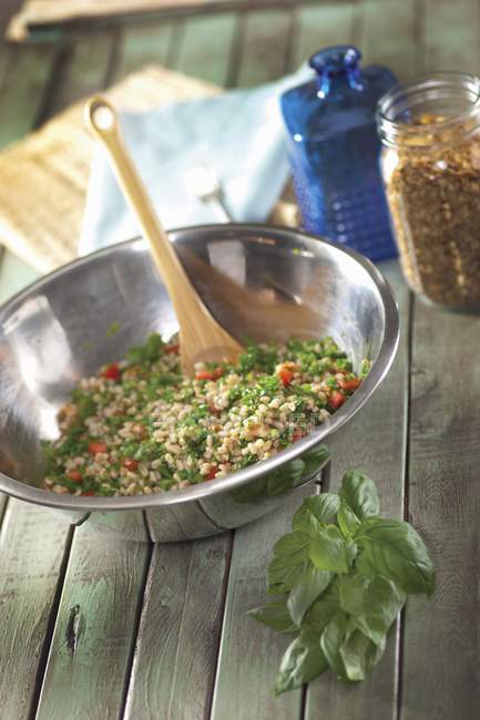 Bulgur salad with basil in metal bowl — Stock Photo