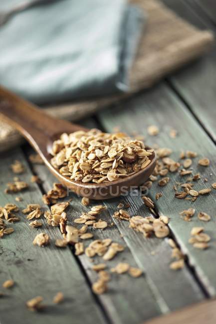 Oats granola on wooden spoon — Stock Photo