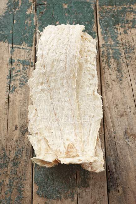 Top view of Icelandic dried fish on a wooden surface — Stock Photo