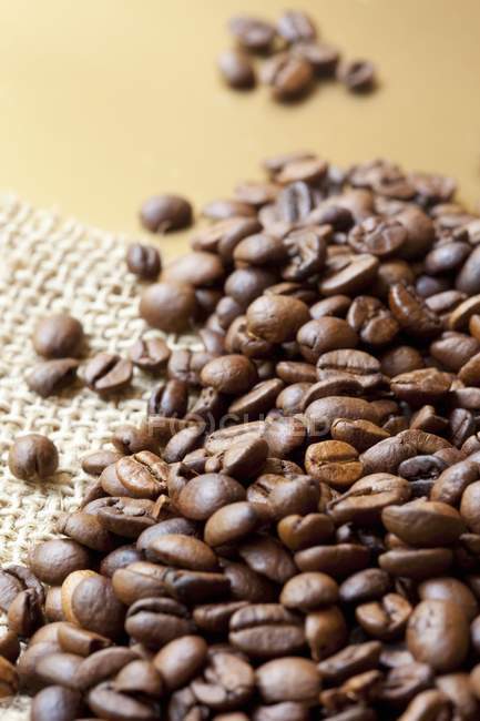 Coffee beans on jute — Stock Photo