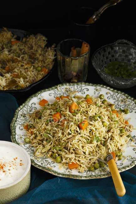 Pilau with coriander and peppermint on plate with fork — Stock Photo