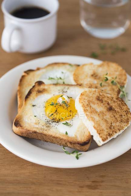 Closeup view of a fried eggs on toasts — Stock Photo
