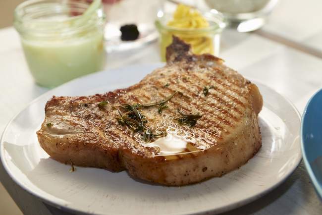 Organic pork chop with curry butter — Stock Photo