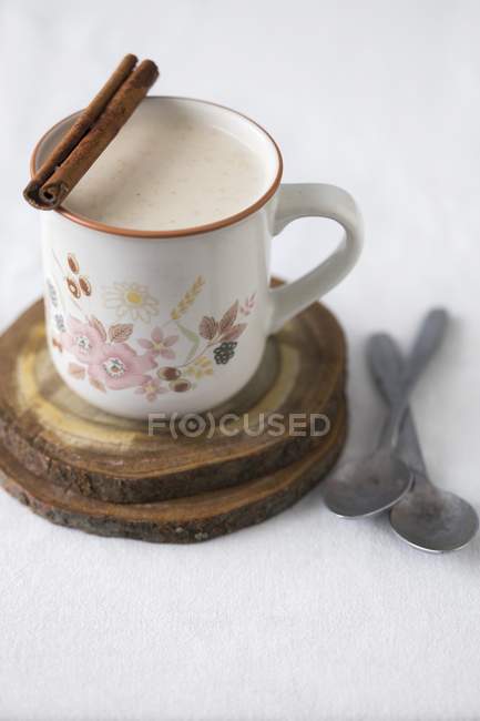 Hot milk in mug with cinnamon — Stock Photo