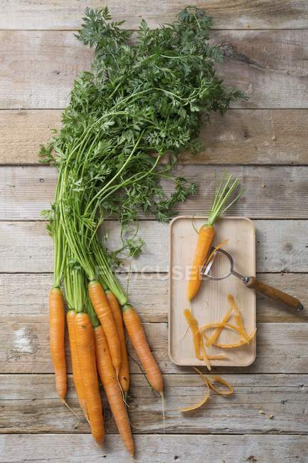 Fresh carrots on board — Stock Photo