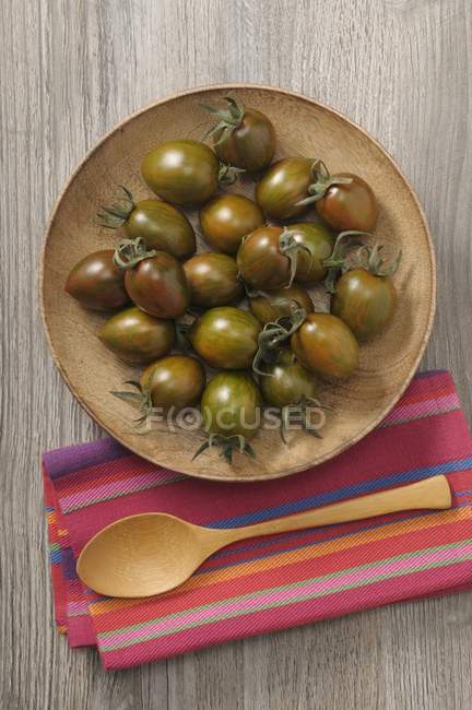 Tomates negros en plato - foto de stock