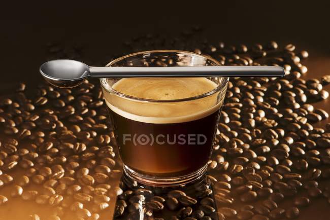 Glass of espresso with spoon — Stock Photo