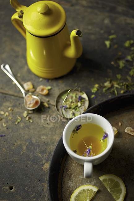 Herb tea with rock sugar and lemon — Stock Photo