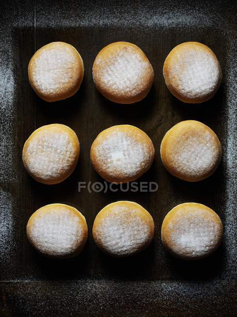 Sugared doughnuts on dark background — Stock Photo