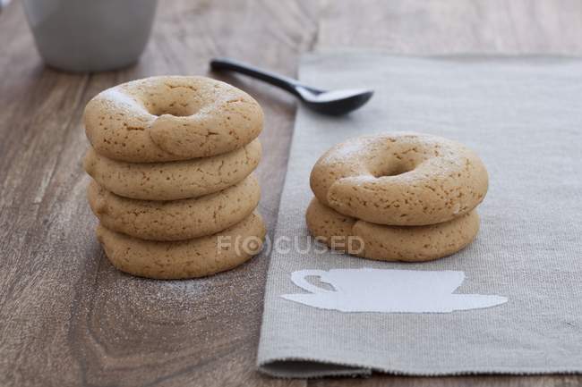 Closeup view of piled Biscotti with anise on cloth and wooden surface — Stock Photo