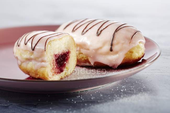 Doughnuts with jam and sugar glaze — Stock Photo
