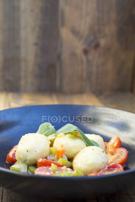Gnocci with tomatoes on plate — Stock Photo