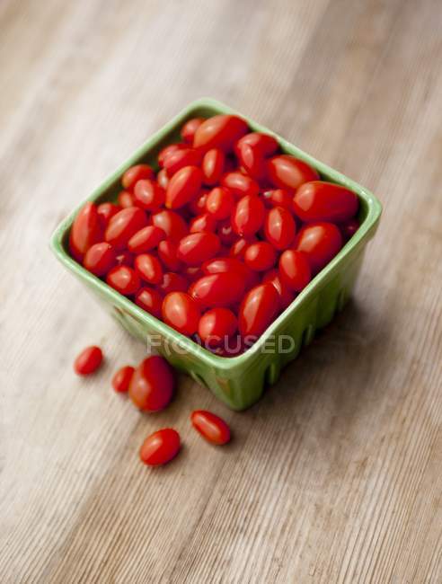 Grape tomatoes in container — Stock Photo