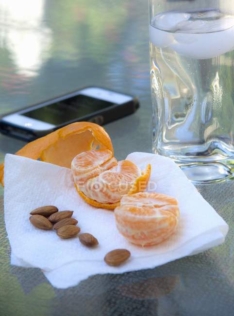 Mandarin and almonds as snack — Stock Photo