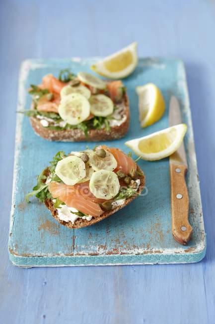 Wholemeal rolls topped with smoked salmon — Stock Photo