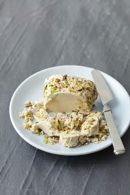 Closeup view of Turkish Halva with pistachio nuts on plate — Stock Photo