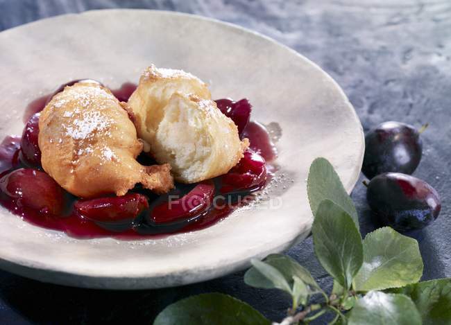 Plum compote on white plate — Stock Photo