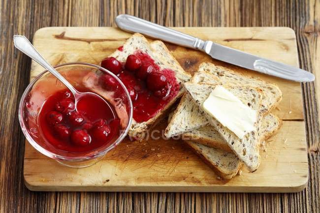 Toast with cherry jam and butter — Stock Photo