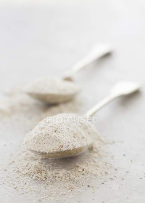 Rye flour on spoons — Stock Photo