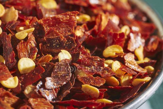 Closeup view of chilli flakes in a metal bowl — Stock Photo