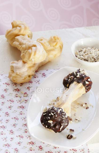 Various eclairs with chocolate icing — Stock Photo