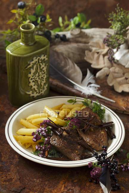 Venison medallions with penne pasta — Stock Photo